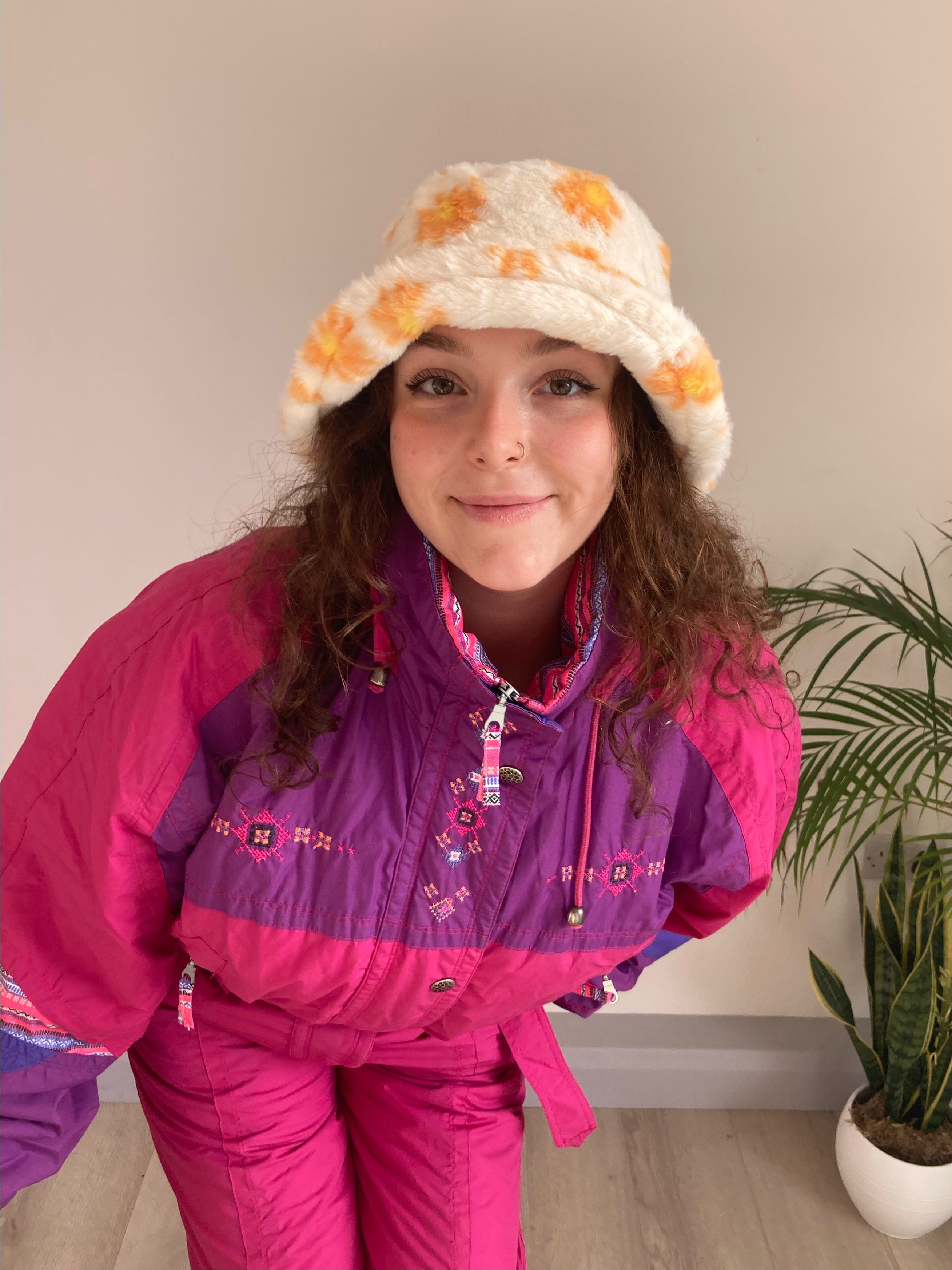 white fluffy bucket hat with orange daisy print